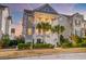 Charming two-story home with double porches and palm trees in the front yard at 1625 Oak Leaf St, Daniel Island, SC 29492
