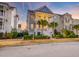 Exterior of home with a porch, balcony, and palm trees at sunset at 1625 Oak Leaf St, Daniel Island, SC 29492