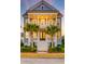 Exterior of home with stately columns, double front doors, and landscaping at 1625 Oak Leaf St, Daniel Island, SC 29492