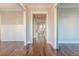 Bright hallway showcasing hardwood floors, wainscoting, and views into adjacent rooms with white trim at 1625 Oak Leaf St, Daniel Island, SC 29492