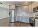 Modern kitchen featuring stainless steel appliances, white subway tile backsplash, and gray cabinets at 1625 Oak Leaf St, Daniel Island, SC 29492
