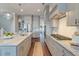 Modern kitchen with an island, marble countertops, stainless steel appliances and custom cabinets at 1625 Oak Leaf St, Daniel Island, SC 29492