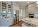 Elegant kitchen with stainless steel appliances, custom cabinets, marble countertops, and hardwood floors at 1625 Oak Leaf St, Daniel Island, SC 29492