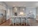 Stylish kitchen with an island, seating, stainless steel refrigerator and custom cabinets at 1625 Oak Leaf St, Daniel Island, SC 29492