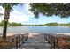 Beautiful lake view with a brick path, stairs, and lush trees at Smythe Lake at 1625 Oak Leaf St, Daniel Island, SC 29492