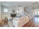 Bright living room with fireplace, ceiling fan, and staircase, creating a welcoming atmosphere at 1625 Oak Leaf St, Daniel Island, SC 29492