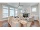 Cozy living room showcasing shiplap, fireplace, plush seating, and an abundance of natural light at 1625 Oak Leaf St, Daniel Island, SC 29492