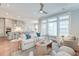 Bright living room featuring plush seating, large windows, and an open-concept layout to the kitchen and dining area at 1625 Oak Leaf St, Daniel Island, SC 29492