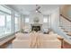 Sunlit living room with fireplace, ceiling fan, and comfortable seating, great for relaxation at 1625 Oak Leaf St, Daniel Island, SC 29492