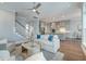 Spacious living room with hardwood floors, staircase, and views of the modern kitchen at 1625 Oak Leaf St, Daniel Island, SC 29492
