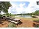 Charming picnic area near the lake, complete with wooden picnic tables and a grill at 1625 Oak Leaf St, Daniel Island, SC 29492