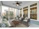 Inviting covered porch with comfortable seating, ceiling fan, and views of the neighborhood at 1625 Oak Leaf St, Daniel Island, SC 29492