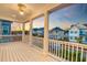 Spacious upper porch with white columns and railings overlooking the street and neighboring homes at 1625 Oak Leaf St, Daniel Island, SC 29492
