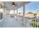 Relaxing covered porch featuring white columns, wooden floors, and scenic neighborhood views at 1625 Oak Leaf St, Daniel Island, SC 29492
