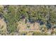Aerial view showcasing the expansive land, various structures, and lush greenery surrounding the property at 1677 French Santee Rd, Jamestown, SC 29453