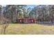 Exterior view of a charming red barn with white trim and crossbuck doors at 1677 French Santee Rd, Jamestown, SC 29453