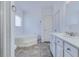 Well-lit bathroom features a large soaking tub, tile floors, and modern white vanity at 1677 French Santee Rd, Jamestown, SC 29453
