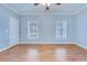 Bright bedroom with neutral walls, two windows, and a light-colored hardwood floor at 1677 French Santee Rd, Jamestown, SC 29453