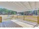 View of deck overlooking fenced backyard and wooded area at 1677 French Santee Rd, Jamestown, SC 29453