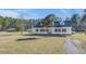 Beautiful home with red shutters, mature trees, and a spacious yard for outdoor activities at 1677 French Santee Rd, Jamestown, SC 29453