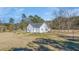 Exterior angle shot of home with a spacious yard and mature trees surrounding the property at 1677 French Santee Rd, Jamestown, SC 29453