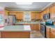Traditional kitchen with wood cabinets, stainless appliances and colorful tile backsplash at 1677 French Santee Rd, Jamestown, SC 29453