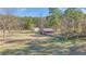 Multiple outbuildings and structures including open barn, sheds, a red house and surrounding fenced field at 1677 French Santee Rd, Jamestown, SC 29453