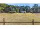 View of the expansive land area with various buildings and a natural treeline in the background at 1677 French Santee Rd, Jamestown, SC 29453