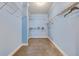 Walk-in closet offers abundant hanging space with sturdy shelving and neutral carpeting at 1677 French Santee Rd, Jamestown, SC 29453