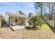 Backyard featuring a wooden deck with outdoor seating, mature trees, and a fenced perimeter at 1723 River Front Dr, Charleston, SC 29407