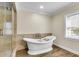 Elegant bathroom showcasing a freestanding tub, tiled shower, modern fixtures, and tiled floors at 1723 River Front Dr, Charleston, SC 29407