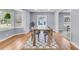 Elegant dining room with large windows, wood floors, and neutral decor at 1723 River Front Dr, Charleston, SC 29407