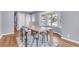 Bright dining area with a bay window and a modern table setting for four at 1723 River Front Dr, Charleston, SC 29407
