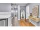 Well-lit hallway features tile and wood flooring with a decorative mirror and accent table at 1723 River Front Dr, Charleston, SC 29407