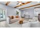 Bright living room with wood beams, modern furniture, and light-colored flooring at 1723 River Front Dr, Charleston, SC 29407