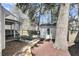 Landscaped backyard featuring shed, a wooden walkway, and mature trees at 1782 Towne St, Johns Island, SC 29455