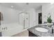 Elegant bathroom featuring a soaking tub, glass-enclosed shower, and granite countertop vanity at 1782 Towne St, Johns Island, SC 29455