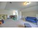 Spacious bonus room featuring a blue sofa and plenty of space for activities and storage at 1782 Towne St, Johns Island, SC 29455