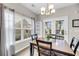 Cozy dining area featuring a chandelier, natural light, and adjacent outdoor access at 1782 Towne St, Johns Island, SC 29455