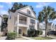 Beautiful two-story home featuring a cozy front porch, manicured lawn, and attractive landscaping, perfect for suburban living at 1782 Towne St, Johns Island, SC 29455