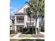 Charming two-story home featuring a welcoming front porch and beautifully landscaped front yard with mature palm tree at 1782 Towne St, Johns Island, SC 29455