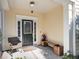 Inviting front porch with classic door, side-light window, bench, chair, and stylish outdoor decor creating a cozy entrance at 1782 Towne St, Johns Island, SC 29455