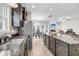 Modern kitchen featuring stainless steel appliances, a granite island, and open-concept layout with a dining and living area at 1782 Towne St, Johns Island, SC 29455