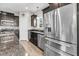 Well-equipped kitchen featuring stainless steel appliances, granite countertops, and dark wood cabinetry at 1782 Towne St, Johns Island, SC 29455
