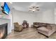 Comfortable living room with a fireplace, ceiling fan, and plush seating at 1782 Towne St, Johns Island, SC 29455