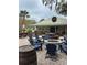 Outdoor patio with multiple tables, Adirondack chairs, and a community fire pit at 1782 Towne St, Johns Island, SC 29455