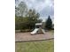 Community playground area with a slide, climbing stairs, and wood chip ground cover at 1782 Towne St, Johns Island, SC 29455