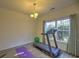 Well-lit room features a treadmill, fitness ball, and yoga mat, perfect for a home workout space with a large window at 1782 Towne St, Johns Island, SC 29455