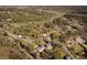 An aerial view shows single Gathering homes surrounded by mature trees and a view of the marsh in the distance at 1981 Central Park Rd, Charleston, SC 29412