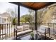 Inviting balcony featuring comfortable seating and a serene view of the surrounding trees and neighborhood at 1981 Central Park Rd, Charleston, SC 29412
